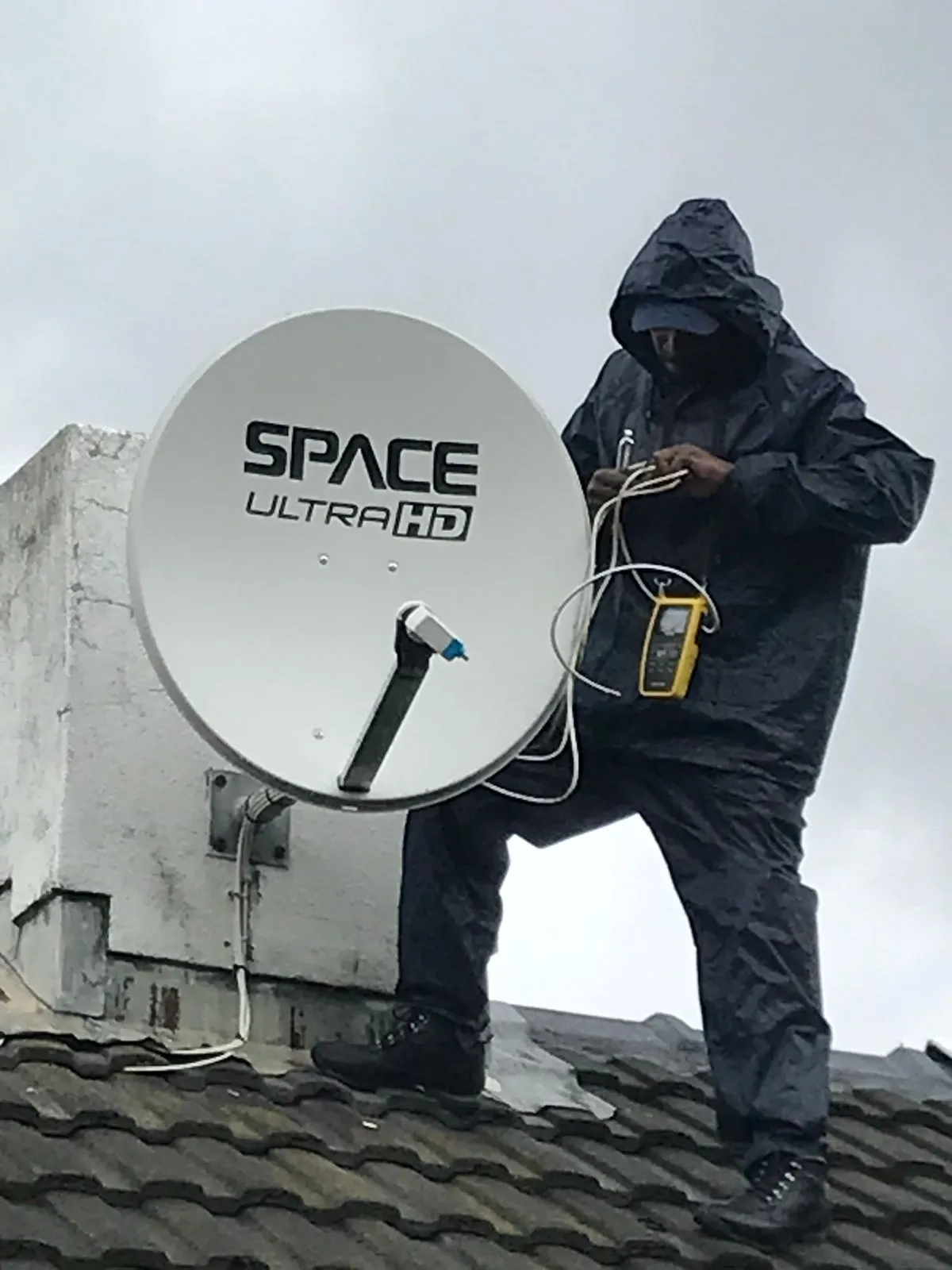 DStv technician installing a satellite dish